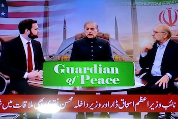 El vicepresidente de Estados Unidos, JD Vance (izquierda), junto al primer ministro pakistaní, Shehbaz Sharif (centro), y el presidente del Parlamento iraní, Mohammad Bagher Ghalibaf (derecha), aparecen en una pantalla de televisión en Peshawar (Pakistán), durante las conversaciones entre Estados Unidos e Irán en Islamabad, Pakistán, el 11 de abril de 2026. EFE/BILAWAL ARBAB