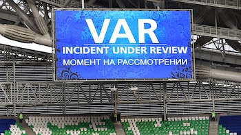 A giant screen reports a