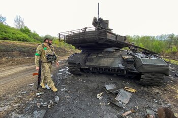 Ukrainian serviceman walks next to