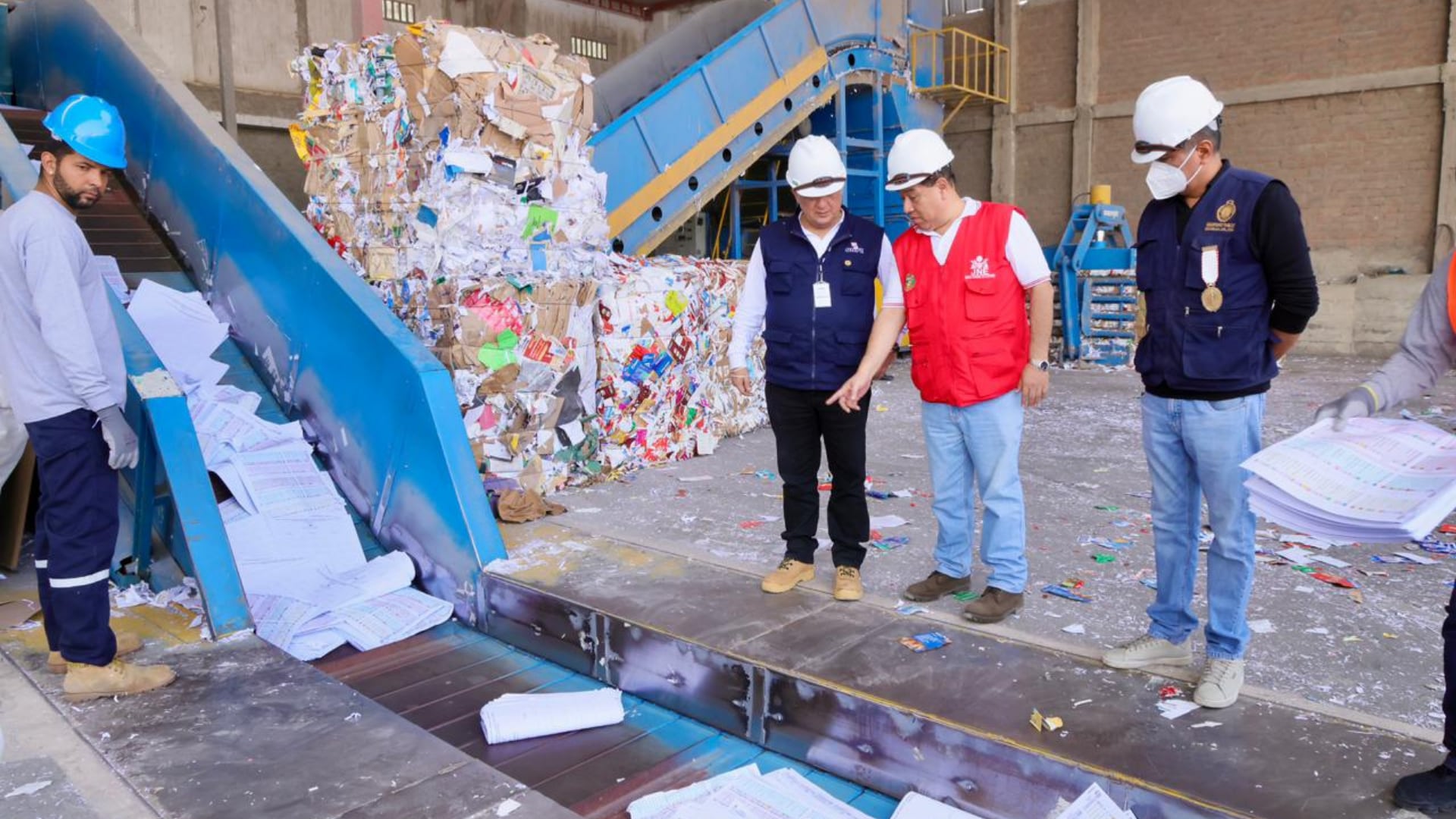 Representantes de la ONPE y del JNE supervisan la trituración de las cédulas de sufragio en una planta industrial del distrito de Ventanilla, en Callao. (ONPE)