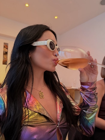 Con lentes que decían "Bride" y un look holográfico, Lali Espósito dio el primer sorbo oficial a su vida de novia durante la celebración en Brasil
