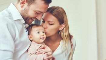 Smiling mother and father holding