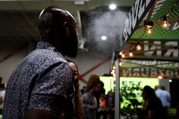 A man exhales as he uses a THC vape during the Cannadelic Miami expo, in Miami, Florida, U.S. February 5, 2022. REUTERS/Marco Bello