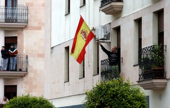 A man waves a Spanish