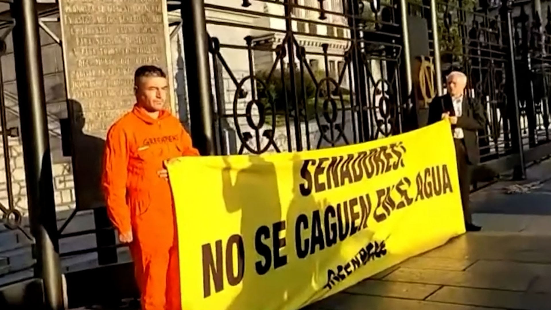 Dos ambientalistas de Greenpeace fueron detenidos mientras protestaban frente al Congreso Nacional contra la ley de Glaciares, sosteniendo una pancarta amarilla con un mensaje. (Captura de video)