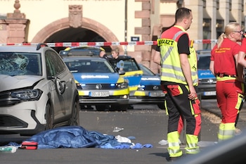 Personal de rescate se encuentra junto a un vehículo dañado que atropelló a varias personas en Leipzig, Alemania, el lunes 4 de mayo de 2026 (Sebastian Willnow/dpa vía AP)