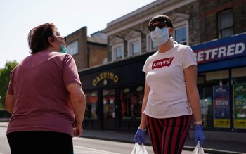 Women wearing face masks speak