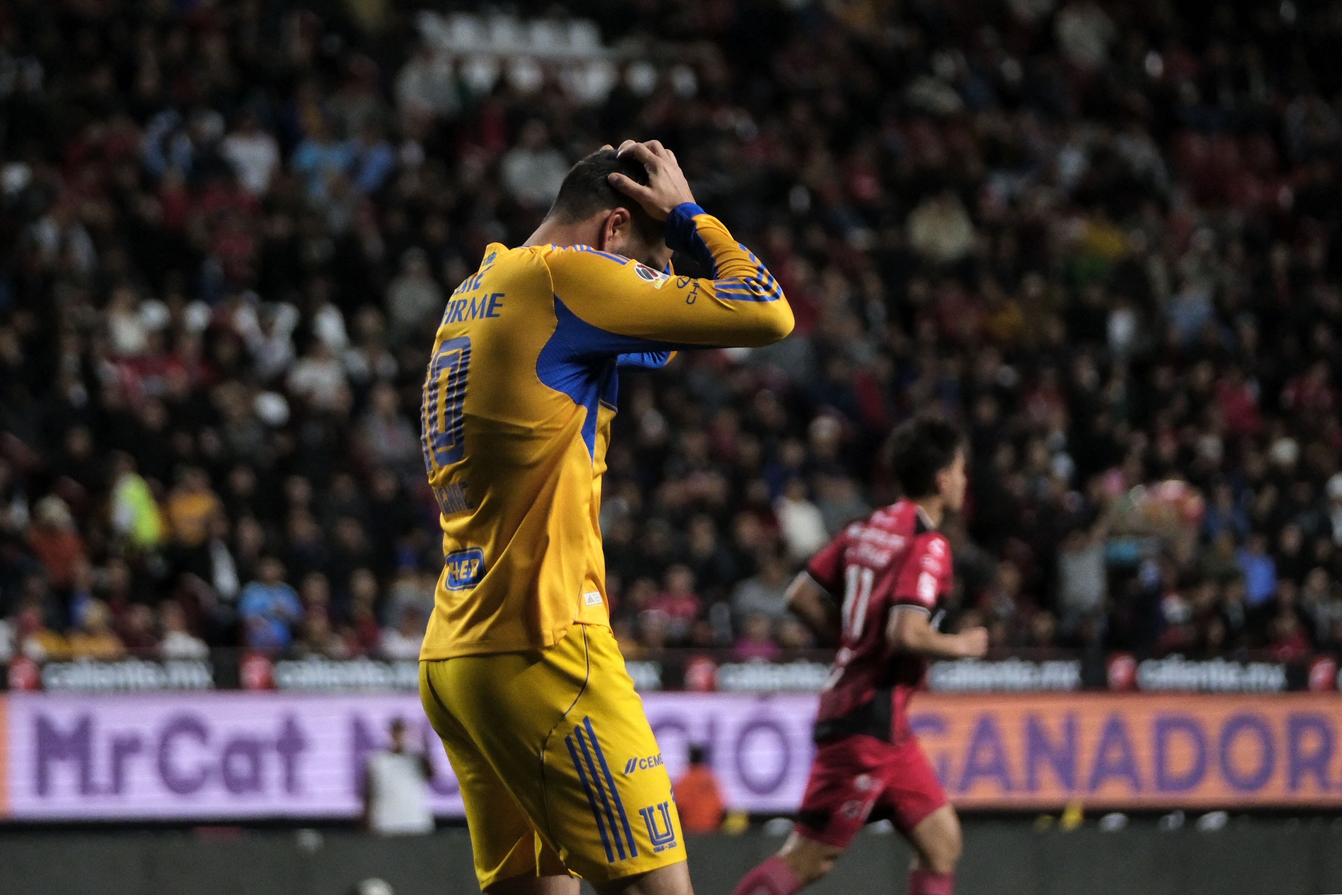 Tigres French forward #10 Andre-Pierre Gignac reacts to a missed chance during the first leg of the Liga MX Clausura quarterfinal match between Tijuana and Tigres at Caliente Stadium in Tijuana, Baja California State, Mexico, on November 26, 2025. (Photo by Guillermo Arias / AFP)