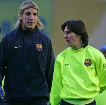 Maxi López con chaqueta deportiva oscura y Lionel Messi con sudadera verde llevan el escudo del Barcelona en el pecho