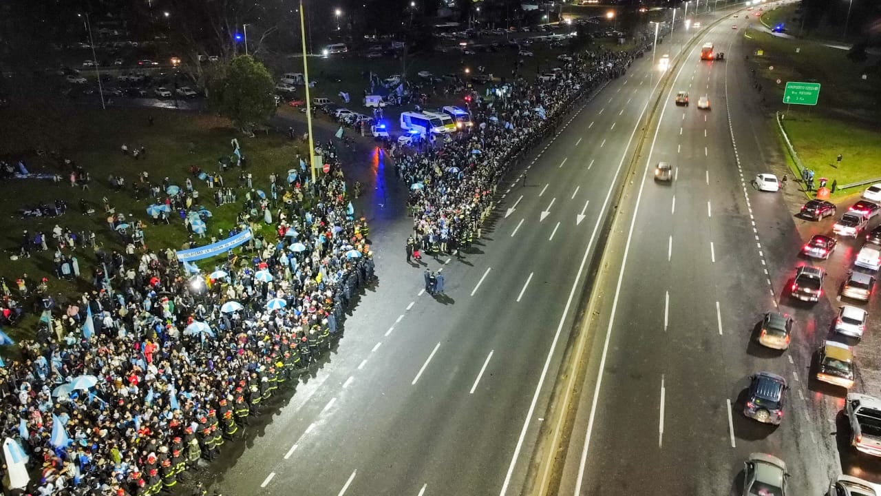 Decenas de miles de personas se apostaron a ambos lados de la autopista Riccheri bajo la lluvia para ver pasar el micro descapotable con los jugadores de la selección argentina (RS Fotos)