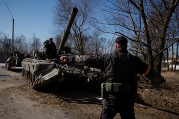 A Ukrainian soldier directs a