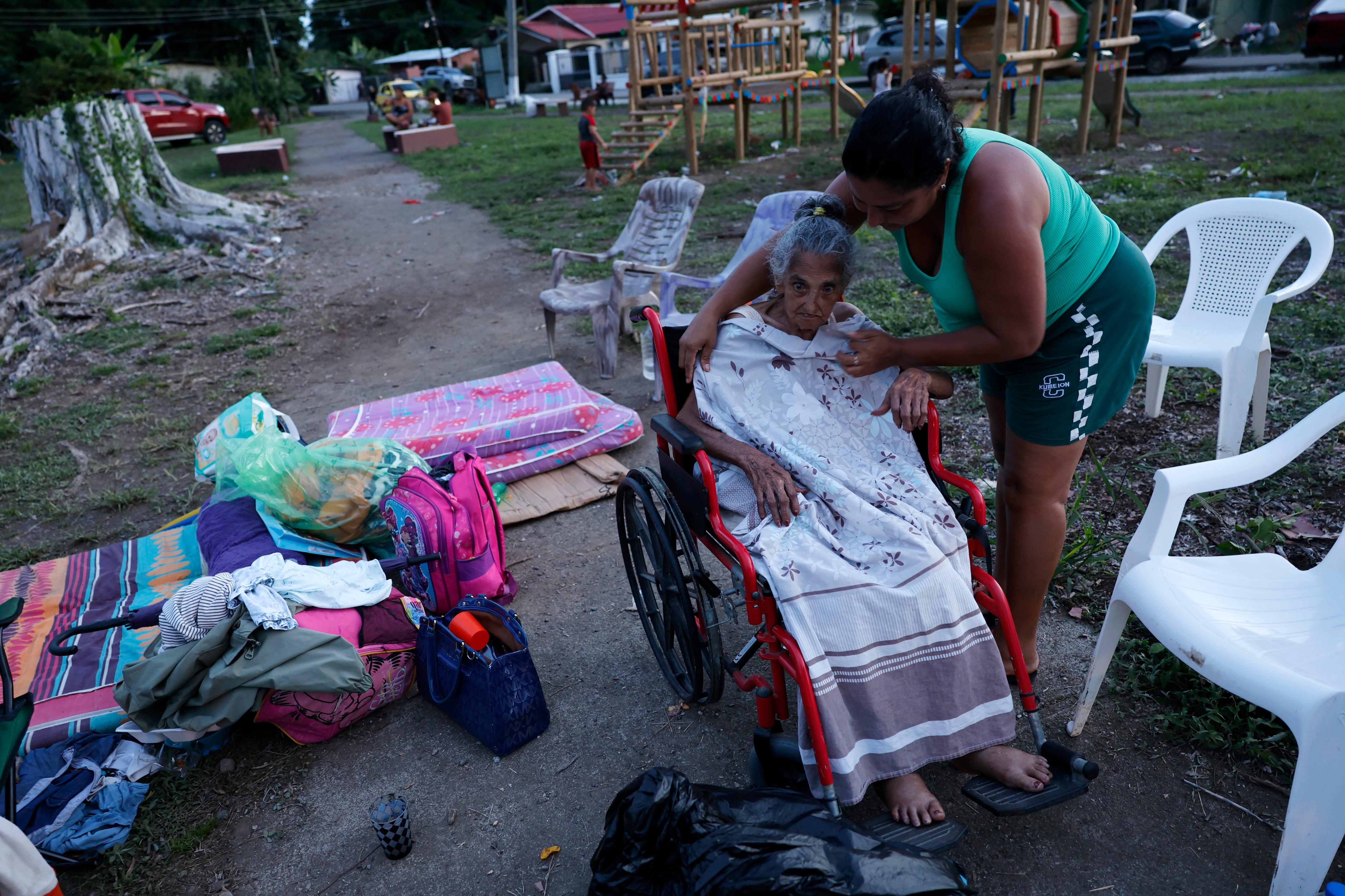 Librada Saavedra (45 años) ayuda a su abuela Elodia Oliva (94 años) en un parque en el centro de Tonosí (Panamá). EFE/ Bienvenido Velasco
