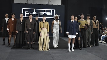 Un grupo de modelos posa sobre una pasarela frente a un fondo negro con la palabra Polystel