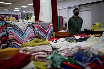 A salesman wears a face