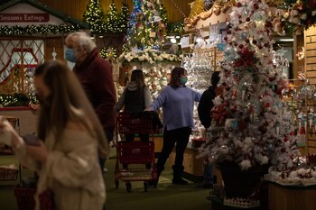 Customers wearing protective masks shop