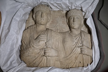 Palmyrene funerary reliefs that once adorned the walls of tombs and date to the second and third centuries A.D. are displayed after Syrian authorities unveiled antiquities returned from France at the National Museum in Damascus, Syria, Wednesday, July 8, 2026. (AP Photo/Ghaith Alsayed)