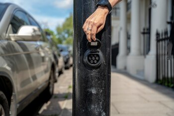 A Ubitricity car charging point installed in a lamppost in London on June 8, 2021. The acquisition of Ubitricity, which installs electric vehicle charging points in lampposts and other structures in London and other cities, is an example of Royal Dutch ShellÕs steps toward greener operations. (Andrew Testa/The New York Times)