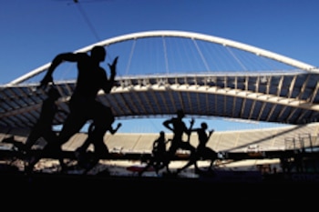 Athens, GREECE: Athletes compete in the Men's 100m during the 2007 IAAF Tsiklitiria Grand Prix at the Athens Olympic stadium, 02 July 2007. The event was carried off by Derrick Atkins of the Bahamas in 9secs.95. AFP PHOTO / Aris Messinis (Photo credit should read ARIS MESSINIS/AFP/Getty Images)