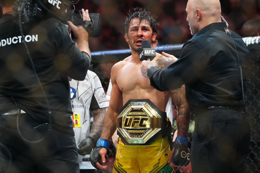 Jul 8, 2023; Las Vegas, Nevada, USA; Alexandre Pantoja (blue gloves) reacts to defeating Brandon Moreno (red gloves) during UFC 290 at T-Mobile Arena. Mandatory Credit: Stephen R. Sylvanie-USA TODAY Sports