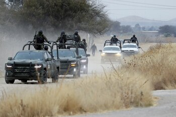 Soldiers and police officers patrol
