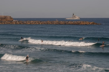 Surfistas disfrutan del oleaje en la playa de la Zurriola de San Sebastián. (EFE/Juan Herrero)