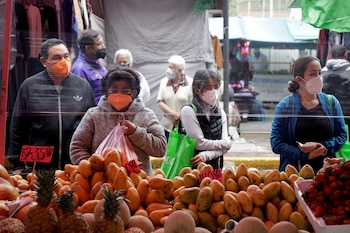 FILE PHOTO: Customers shop fruit