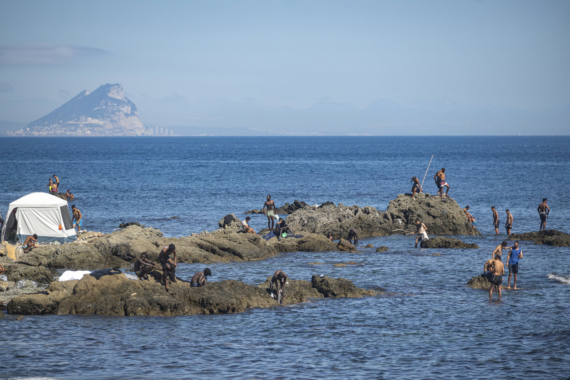 Varios migrantes en la playa del Trampolín, en Ceuta (Marcos Moreno - Europa Press)