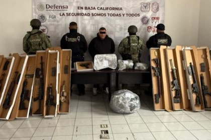 Baja California Arrest: 11 Weapons, Millionaire Drug Bust The man was traveling in
a vehicle in baja California.” loading=