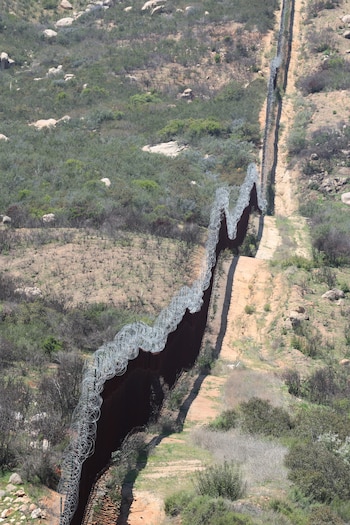 The border wall stretches to the horizon at the Mexico and U.S border in Tecate, California, U.S. April 20, 2025. REUTERS/David Swanson