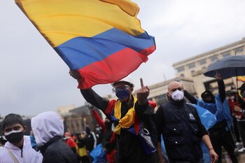SENSITIVE MATERIAL. THIS IMAGE MAY OFFEND OR DISTURB A demonstrator gestures while waving a Colombian flag during a protest against poverty and police violence in Bogota, Colombia, May 5, 2021. REUTERS/Luisa Gonzalez