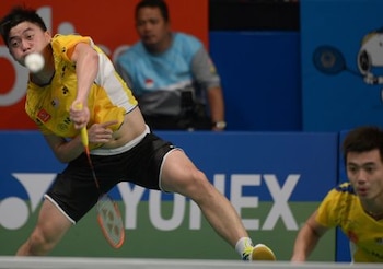 Tan Boon Heong (L) of Malaysia returns a shuttle cock next to Tan Wee Kiong (R) at the 2014 Indonesia Open men double quarter final match against Lee Yong Dae and Yoo Yeon Seong of South Korea in Jakarta on June 20, 2014. Lee Yong Dae and Yoo Yeon Seong won 15-21, 21-6, 21-19. AFP PHOTO / ADEK BERRY (Photo credit should read ADEK BERRY/AFP/Getty Images)