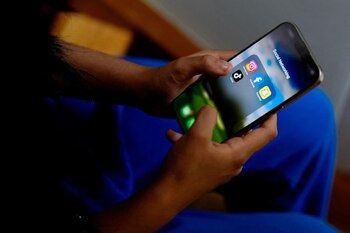 Un estudiante de secundaria posa con su móvil mostrando sus aplicaciones de redes sociales en Melbourne, Australia, el 28 de noviembre de 2024. REUTERS/Asanka Brendon Ratnayake