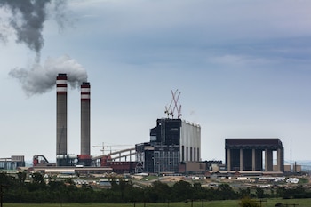 Emissions rise from towers of