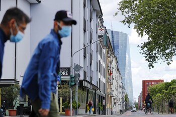 Pedestrians wearing protective face masks