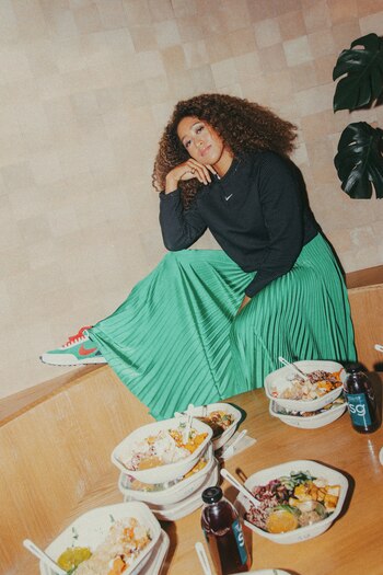 In an undated image provided by Jason Nocito via Sweetgreen, tennis champion Naomi Oasaka with dishes from the Sweetgreen restaurant chain, the latest of many companies to hire her. According to Forbes, Osaka made $37.4 million in endorsements and tournament prizes between May 2019 and May 2020, the most a female athlete has ever earned in a single year. (Jason Nocito, via Sweetgreen via The New York Times) — NO SALES; FOR EDITORIAL USE ONLY WITH NYT STORY OSAKA BRANDING BY SHEILA MARIKAR FOR MAY 19, 2021. ALL OTHER USE PROHIBITED. --