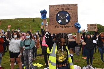 Protesters hold up placards at a demonstration in Edinburgh on June 7, 2020, organised to show solidarity with the Black Lives Matter movement in the wake of the killing of George Floyd, an unarmed black man who died after a police officer knelt on his neck in Minneapolis. - Taking a knee, banging drums and ignoring social distancing measures, outraged protesters from Sydney to London on Saturday kicked off a weekend of global rallies against racism and police brutality. (Photo by ANDY BUCHANAN / AFP)