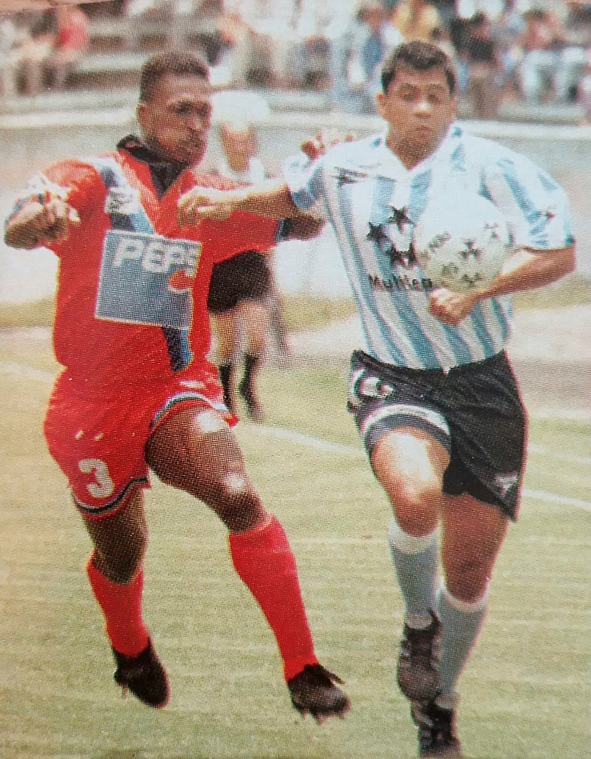 Roberto Saavedra, delantero de Racing, disputa la pelota contra un defensor de El Nacional en Ecuador