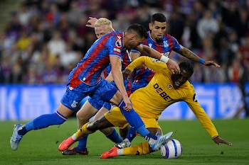 Joel Ward and Daniel Muñoz marking Jean -Ricner Bellegare of the Wolves