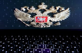 FILE PHOTO: The coat of arms of Russia is reflected in a laptop screen in this picture illustration taken February 12, 2019. REUTERS/Maxim Shemetov/File Photo