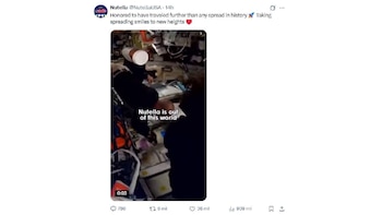 Captura de pantalla de un tweet de NutellaUSA. Se ve un video donde una persona en un entorno espacial sostiene un recipiente blanco, rodeada de paneles y equipo técnico