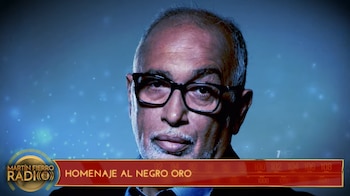 Retrato de un hombre con anteojos y barba canosa junto a un zócalo con el texto Homenaje al Negro Oro y el logotipo de Martín Fierro Radio