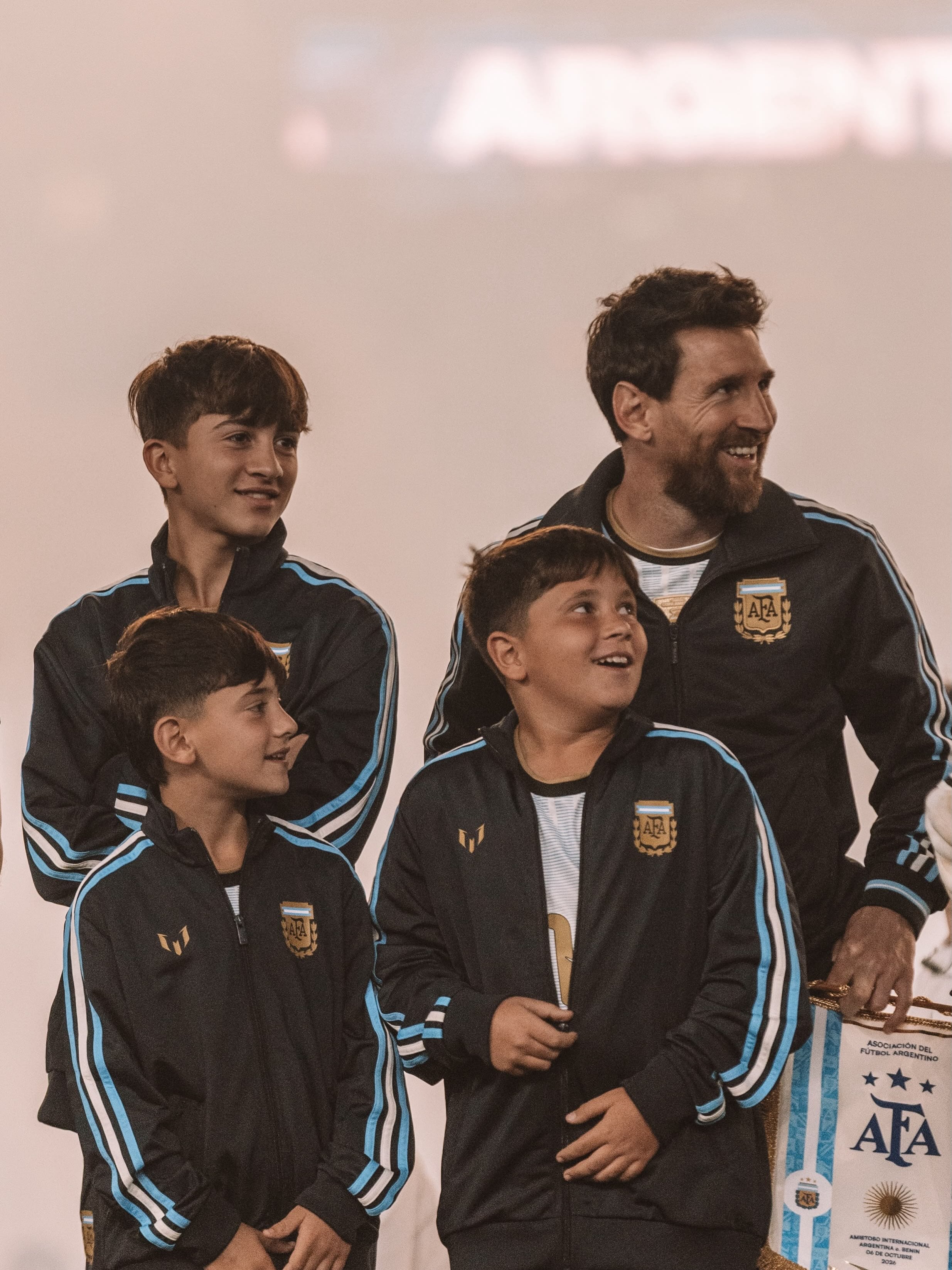 Lionel Messi junto a sus tres hijos, Thiago, Mateo y Ciro, con el buzo oficial de la Asociación del Fútbol Argentino (AFA) antes de su despedida de la selección