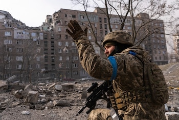A Ukrainian serviceman guards his