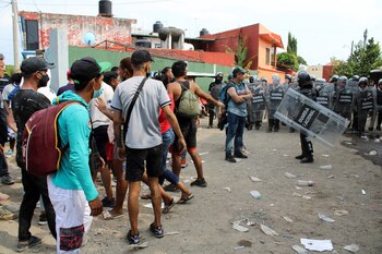 Migrants argue with members of the National Guard after some staff were injured in what was called a "violent" incident at the office of the National Migration Institute (INM) involving migrants who are waiting for papers to be able to freely travel through the country, in Tapachula, Mexico March 18, 2022. REUTERS/Jose Torres