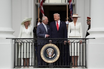 **EMBARGO: No electronic distribution, Web posting or street sales before TUESDAY, 12:01 A.M. ET, OCT. 27, 2026. No exceptions for any reasons. EMBARGO set by source.** FILE — From right: first lady Melania Trump, President Donald Trump, King Charles III, and Queen Camilla watch a pass in review from a balcony of the White House during an arrival ceremony in Washington, April 28, 2026. The king will confront calls for reparations and apologies for his country’s colonial past as he attends the Commonwealth heads of government meeting in the Caribbean. (Salwan Georges/The New York Times)