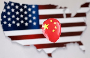FILE PHOTO: A printed balloon with Chinese flag is placed on a U.S. flag in the shape of U.S. map outline, in this illustration taken February 5, 2023. REUTERS/Dado Ruvic/Illustration/File Photo