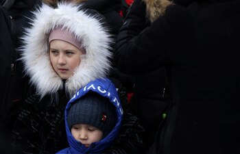 Children arrive by ferry after fleeing from Russia's invasion of Ukraine, at the Isaccea-Orlivka border crossing, Romania, March 13, 2022. REUTERS/Stoyan Nenov