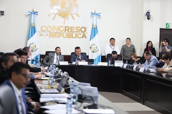 Diputados sentados alrededor de una mesa semicircular en una sala con la inscripción Congreso de la República y banderas de Guatemala