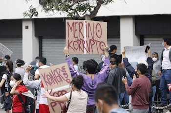 Manifestantes con carteles contra Merino