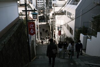 Visitors walk on a flight of stairs near the Kanda Myojin shrine on the first business day of the year in Tokyo, Japan, on Monday, Jan. 4, 2021. Japanese stocks declined on the first trading day of the year following reports of a state of emergency, with the benchmark Topix Index falling as much as 1.6%.